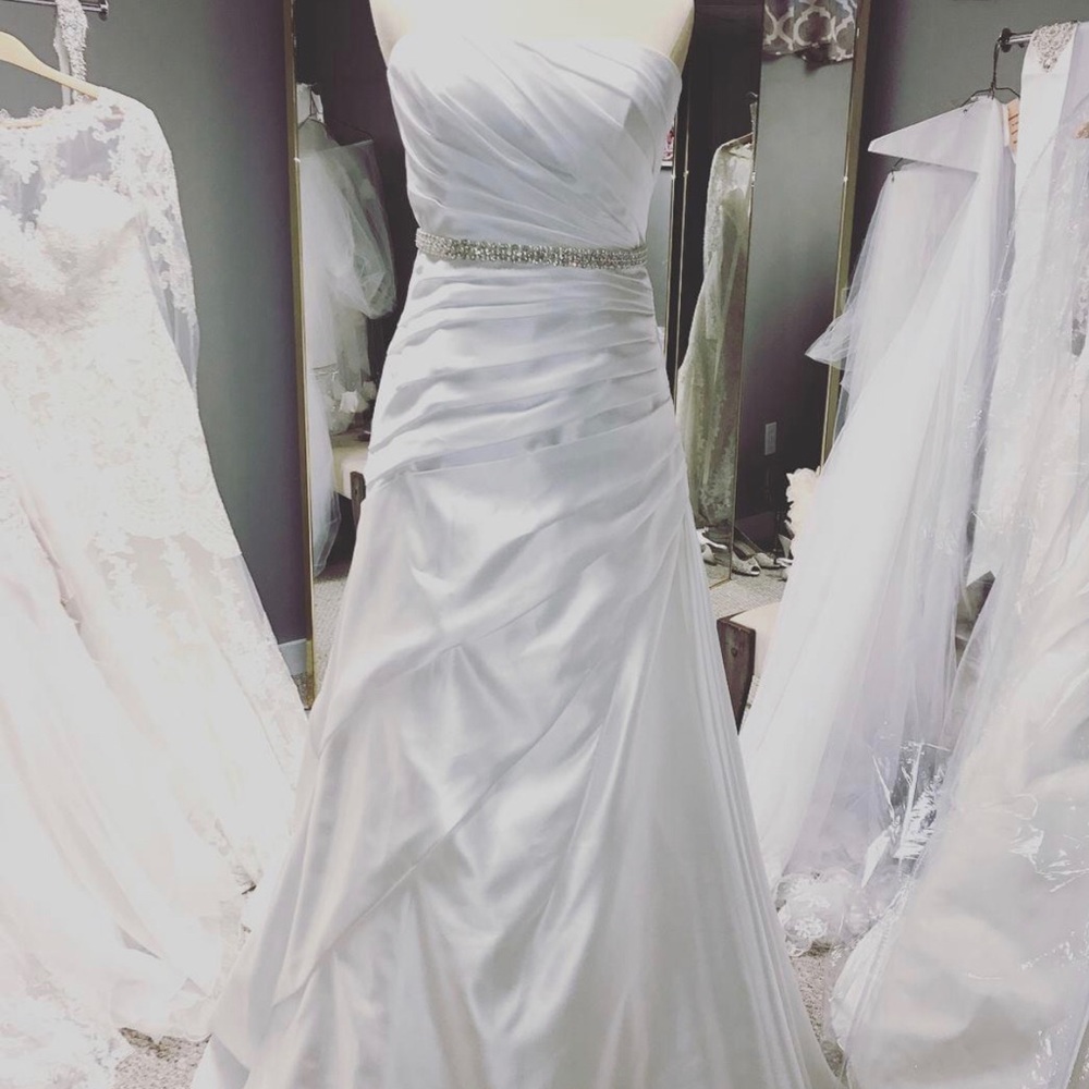 Simple white satin wedding gown.